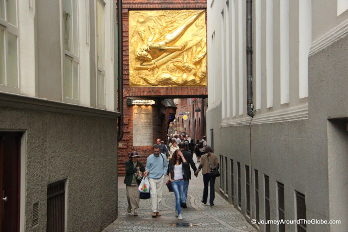 Entering Bottcherstrasse - a golden gilt adorning the gate, Bremen, Germany
