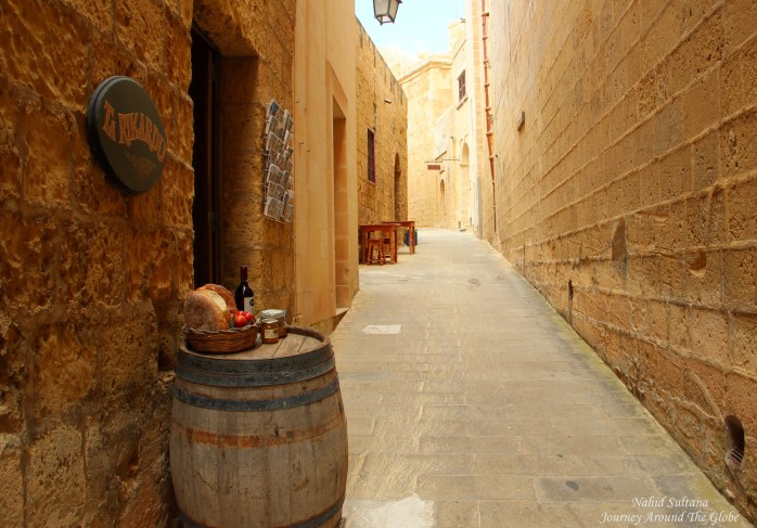 Walking by the old walls of Gozo Citadel in Gozo, Malta