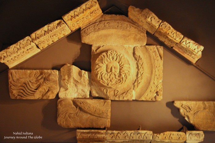 Ruins from Roman temple pediment featuring the Gorgon in Roman Baths of Bath, England