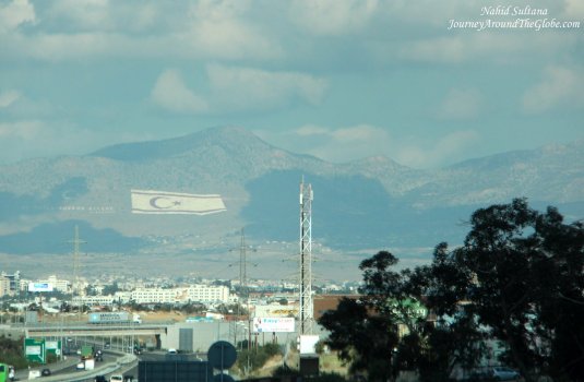 Driving towards Nicosia, you can see a Turkish flag on the mountain