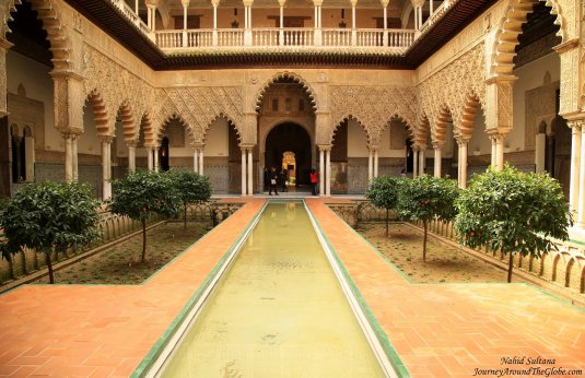 The most beautiful courtyard with pool of Real Alcazar in Seville, Spain