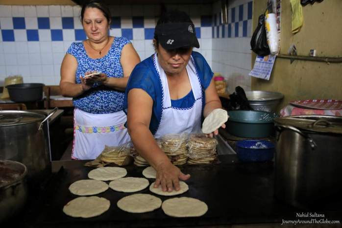 Women making tortilla inside Marcado Municipal de Suchitlan in El Salvador