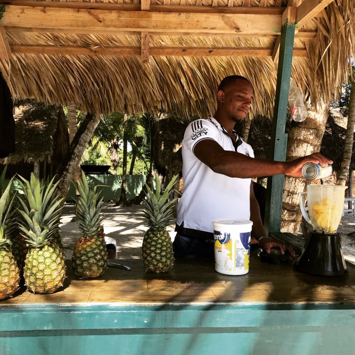 A local making fresh pineapple juice for us in Saona Island, DR
