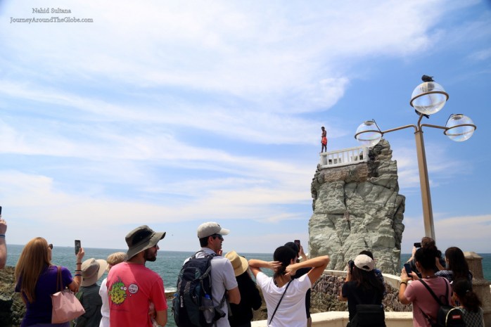 A cliff diver ready to jump to a shallow water body in Mazatlan, Mexico